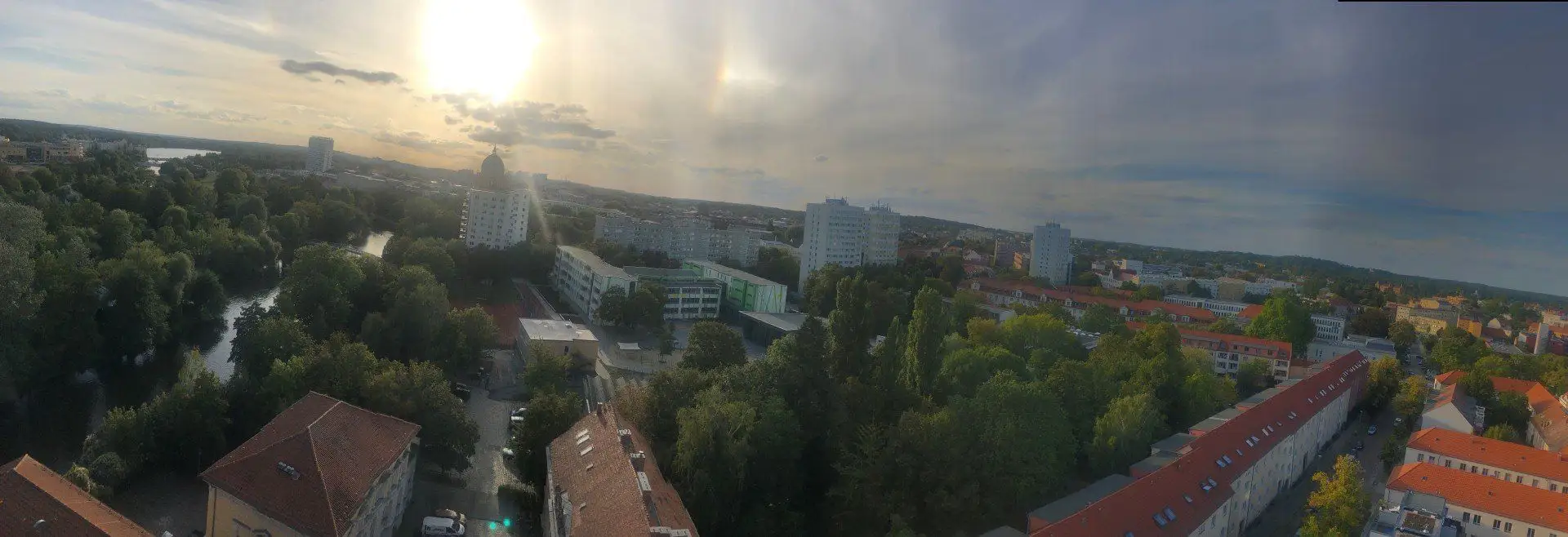Weiter Blick über Potsdam bei tiefstehender Sonne, Havel, Dächer und Baumkronen.